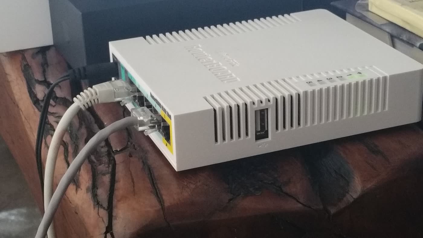 MikroTik RB951Ui-2HnD router with Ethernet cables connected.
